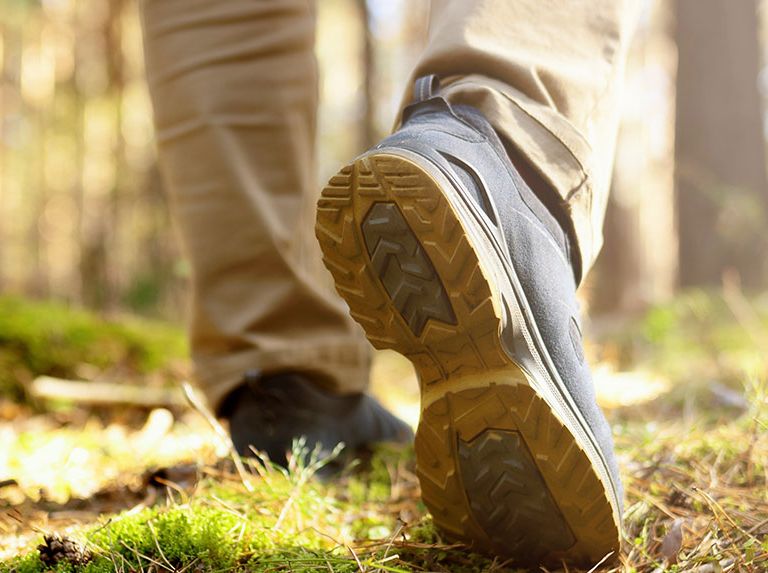 Mens hiking footsteps in the woods 768x573