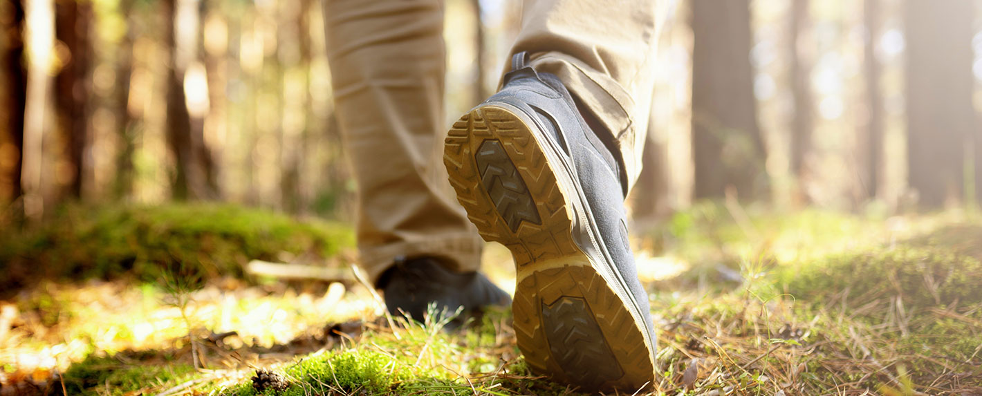 Mens hiking footsteps in the woods